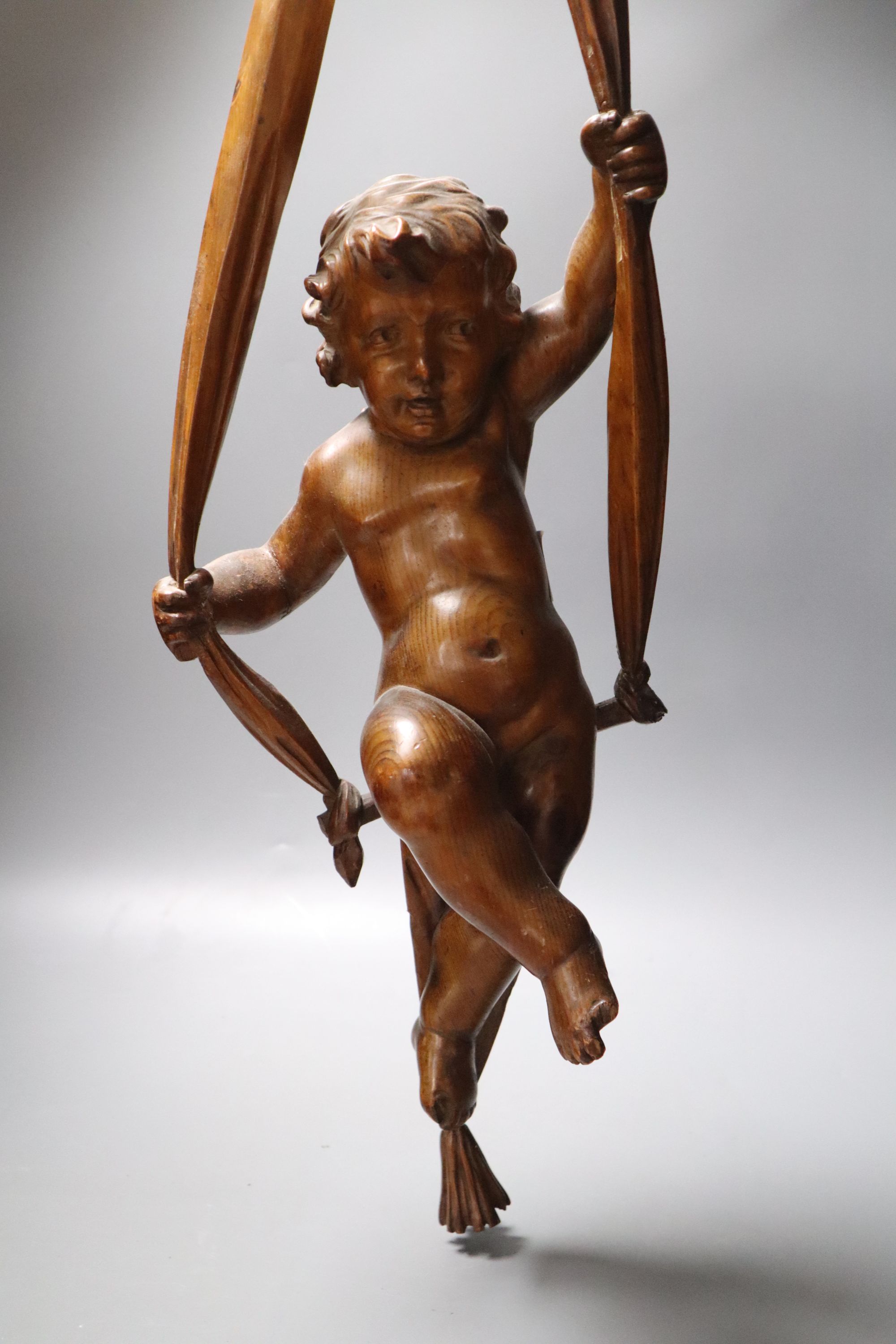 A late 19th century hanging wooden cherub